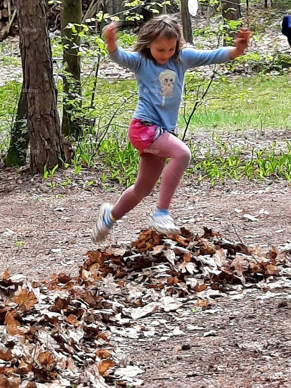 litlle girl running in the forest