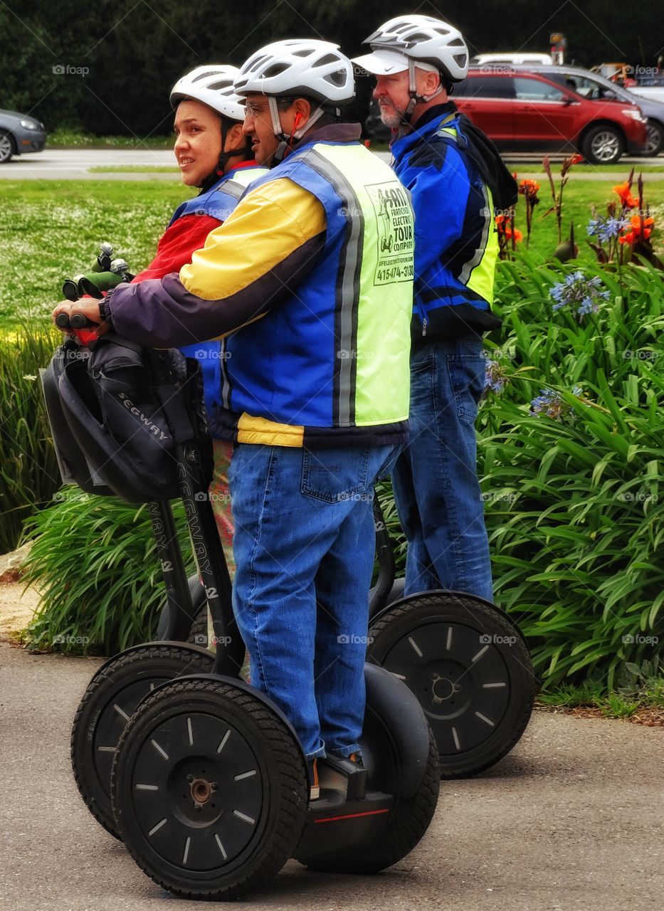 Riding A Segway. Tourists Riding On Segway Pedestrian Vehicle
