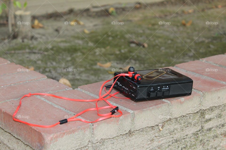cassette player sitting on a red brick wall on a sidewalk in Sacramento California