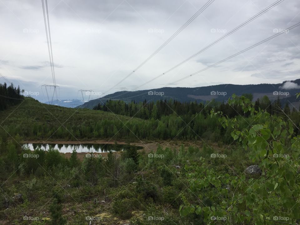 The electrical towers over the water look as though the landscape is smiling at you.