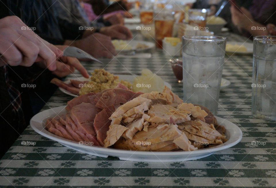 Platter of sliced ham and turkey