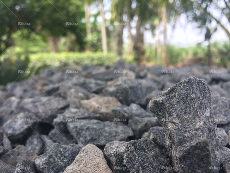 A stone with blur nature background. One stone is focused.