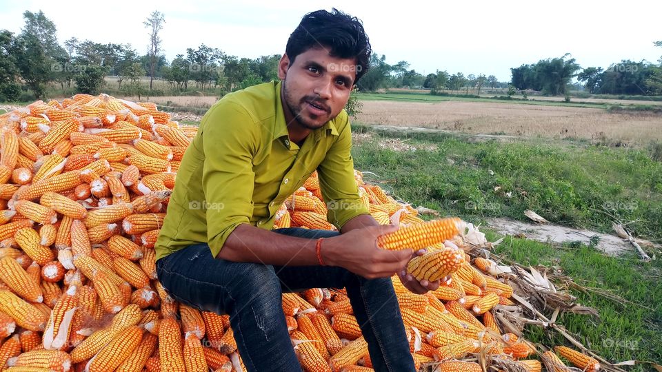 happy farmer with maize