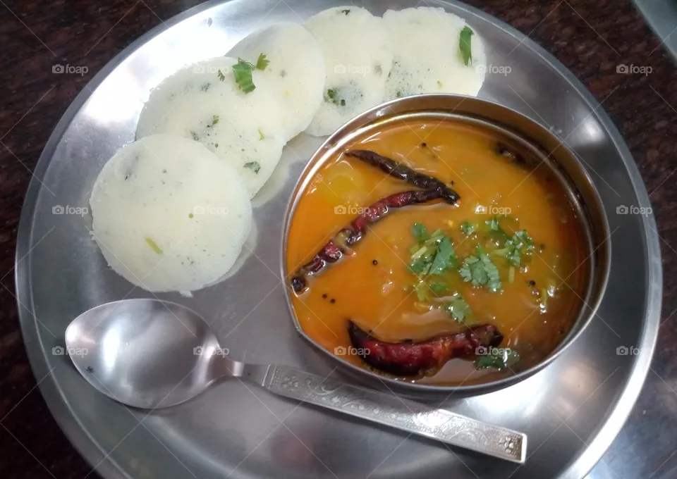 South Indian Dish- Idli Sambar. It is a typical dish made from batter prepared from rice, urad dal, Bengal daal, and a few other kinds of cereal as well. Nowadays, people prefer making idlis from Semolina (Rava). ​​​​