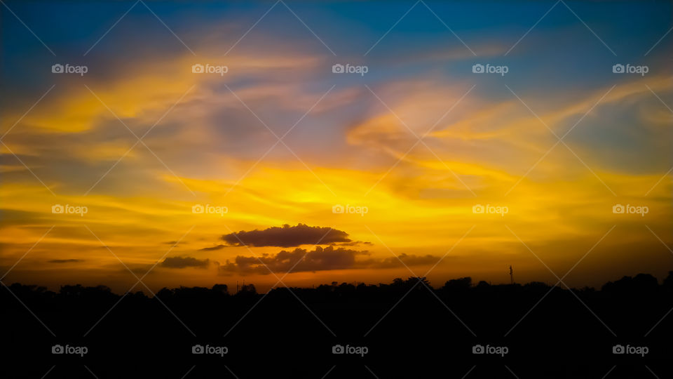 Amazing sunset with colorful cloudscape and dark ocean water, nature background