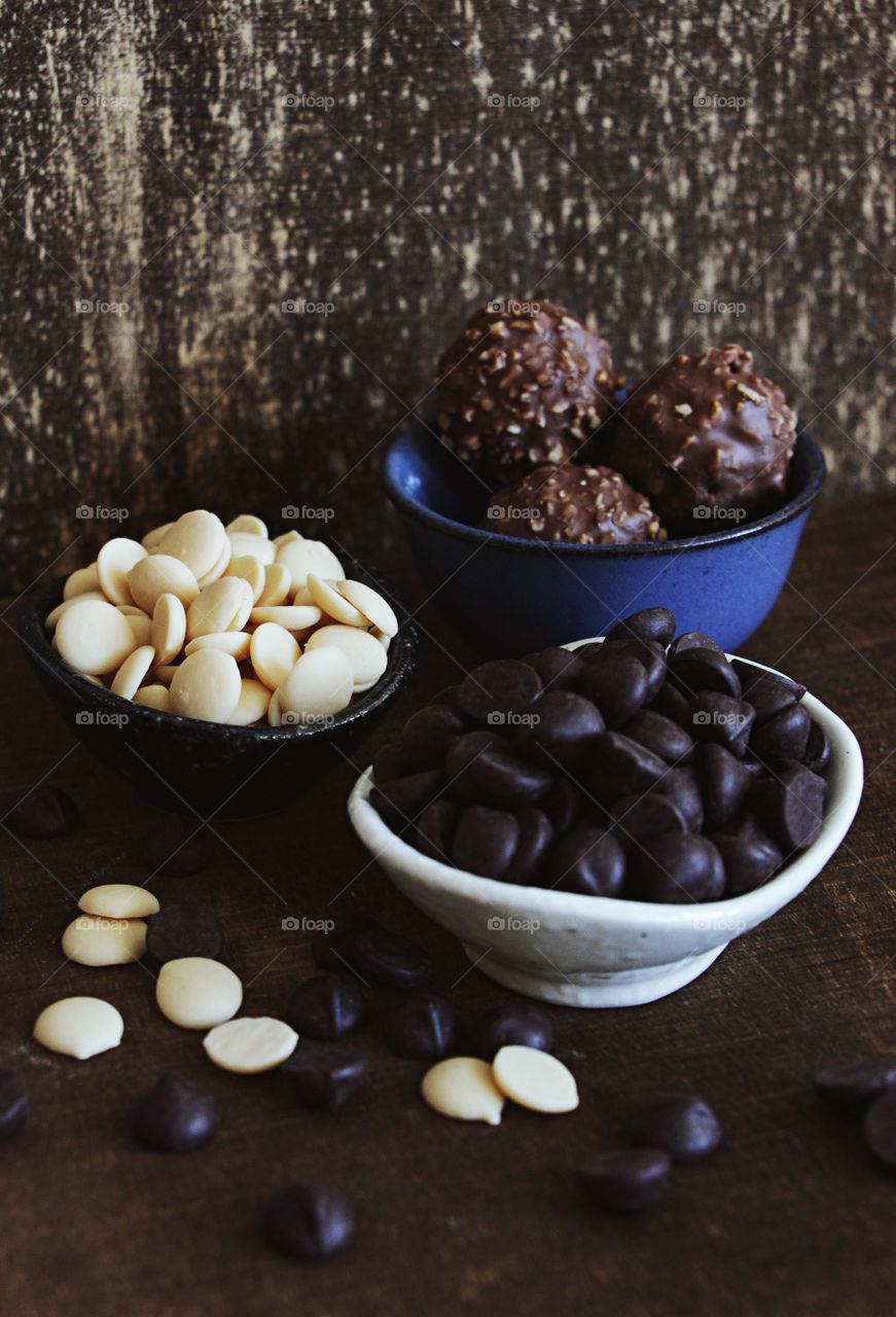 Variety of chocolates, milk chocolate truffles, white chocolate chips, dark chocolate chips