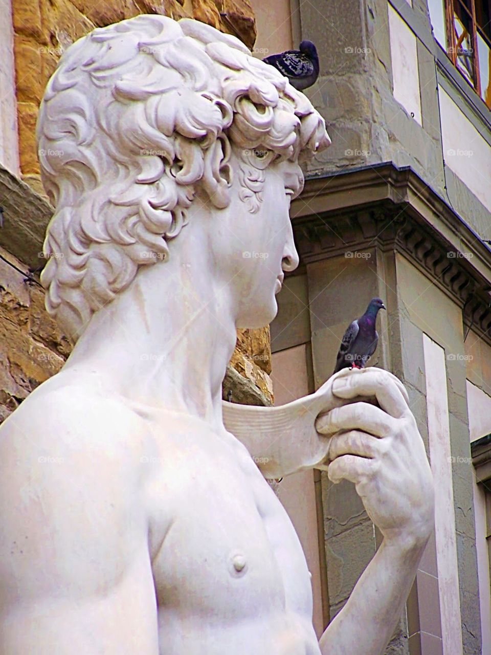 Sculpture of Michelangelo’s David with bird in hand