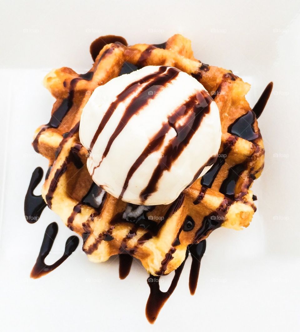 Belgium waffle with vanilla ice cream and chocolate sauce