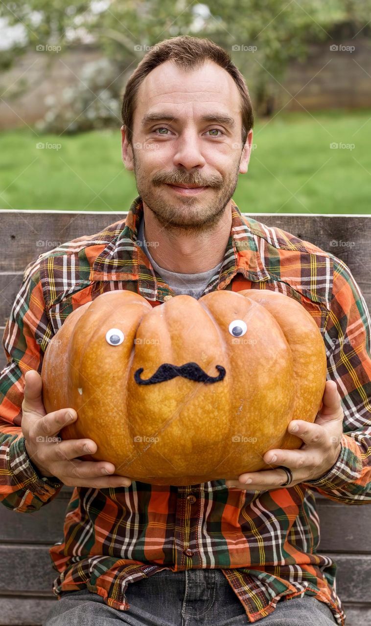 Moustachioed man with moustachioed pumpkin