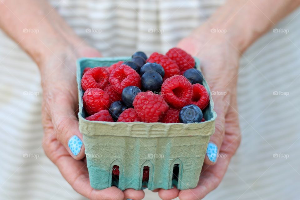 Midsection of woman holding fruits