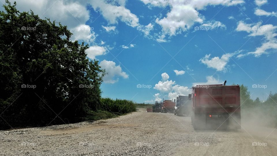 Haul trucks on gravel road