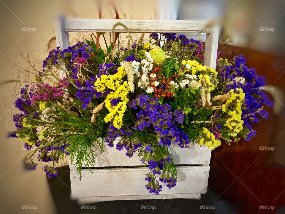 Decorated wood basket with field flowers 