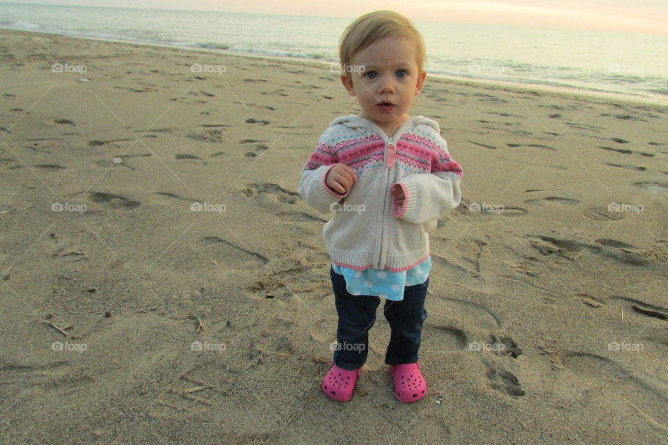 Beach babe . My niece making a silly face after seeing a beach for the first time!