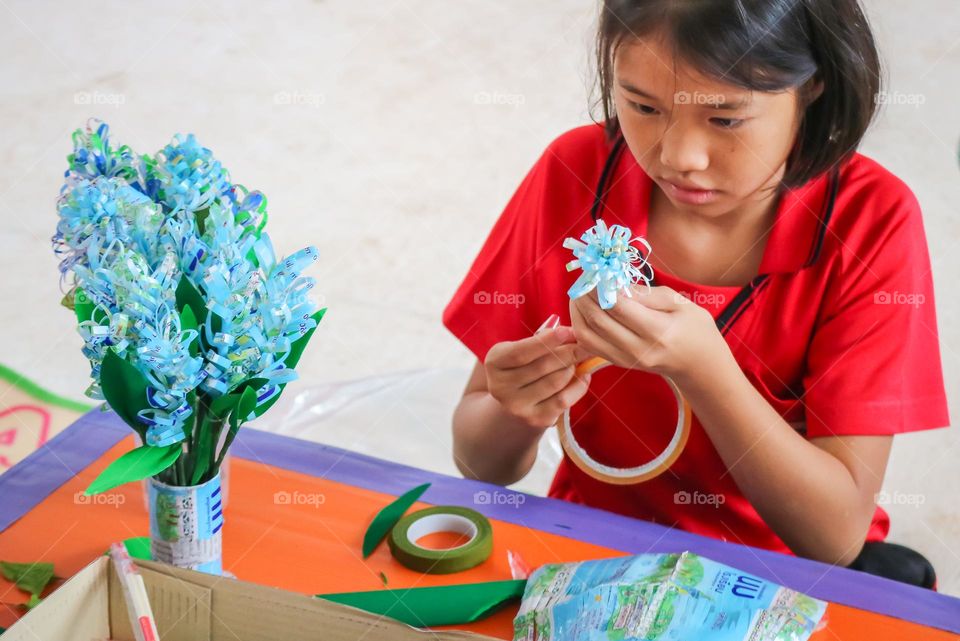 bouquet of flowers in a vase made ftom milk bags.