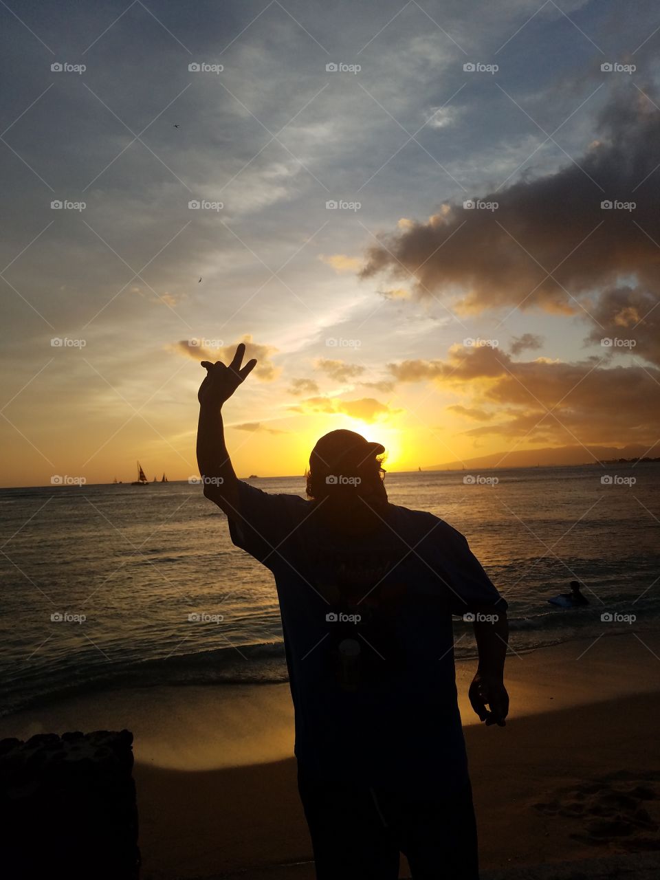 man poses before Waikiki Sunset