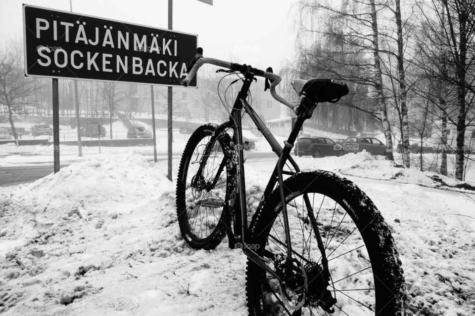 Touring bike in snow. Touring bike in snow on a foggy and wet winter day in Helsinki, Finland. 