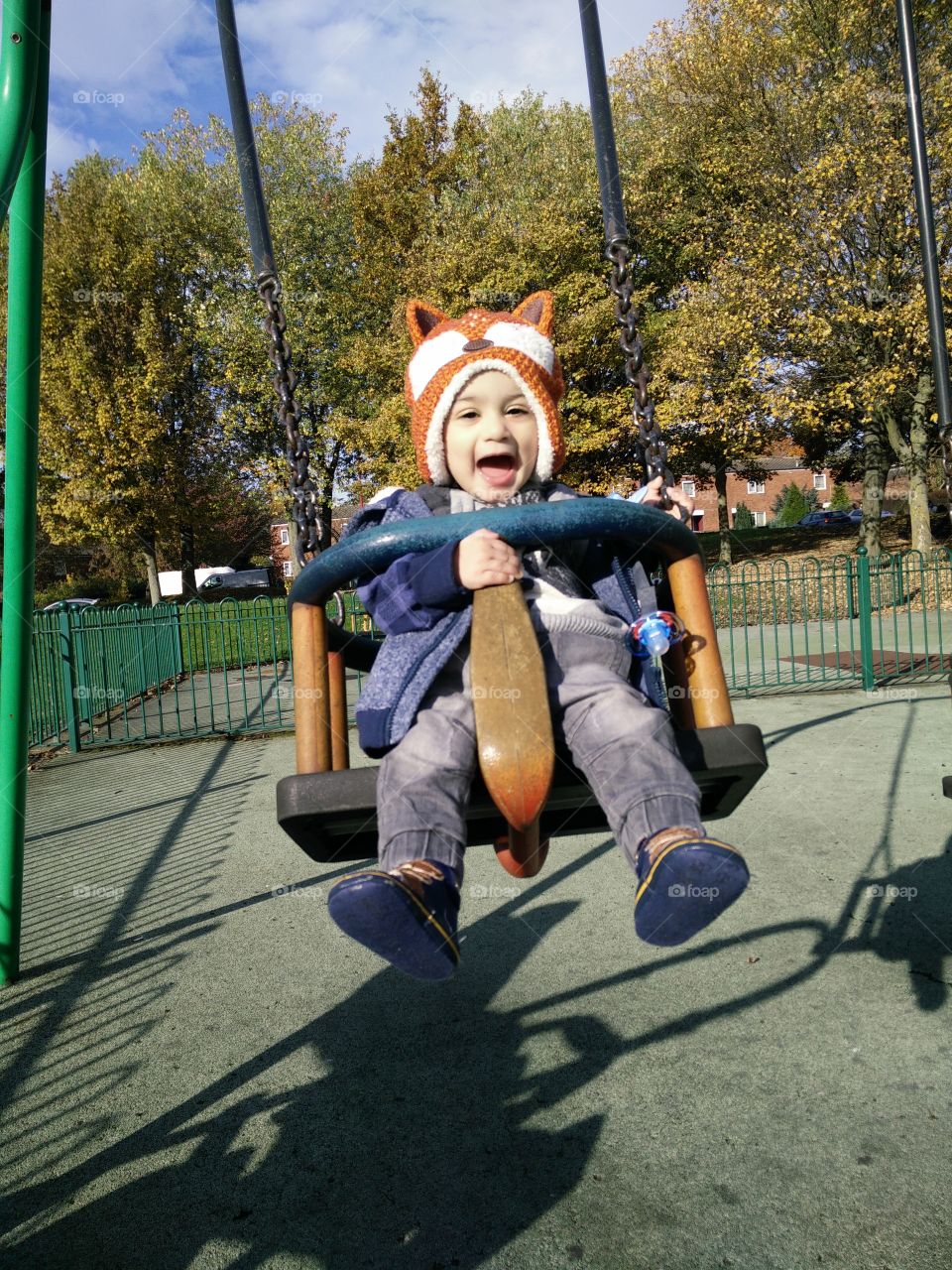 Boy playing on swing