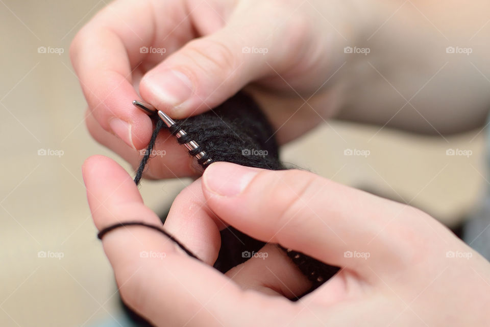 Close-up of a woman's hand knitting