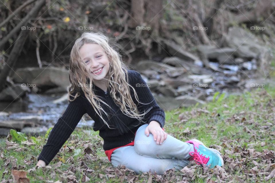 This little girl is full of smiles, giggles, and happiness during our photo shoot by the mountain stream. 