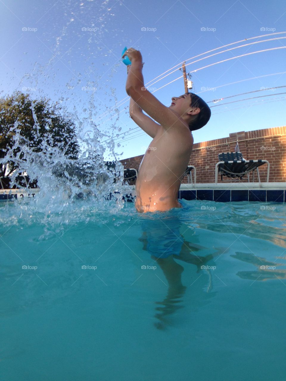 Teenager boy enjoying in swimming pool