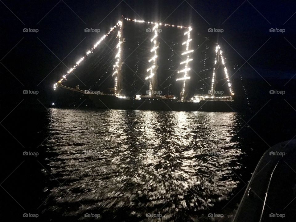 Lit up Sailing ship at night 