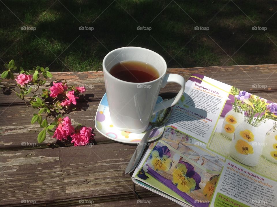 Enjoying a cup of coffee on a beautiful spring day outdoors.