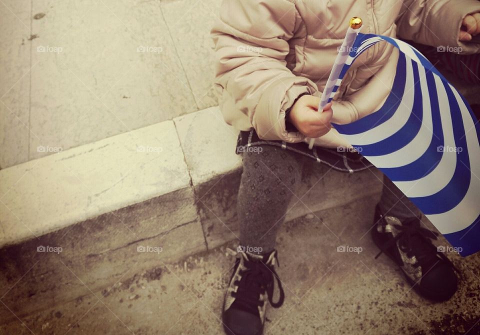 small child, girl, 

holding Greek flag at parade