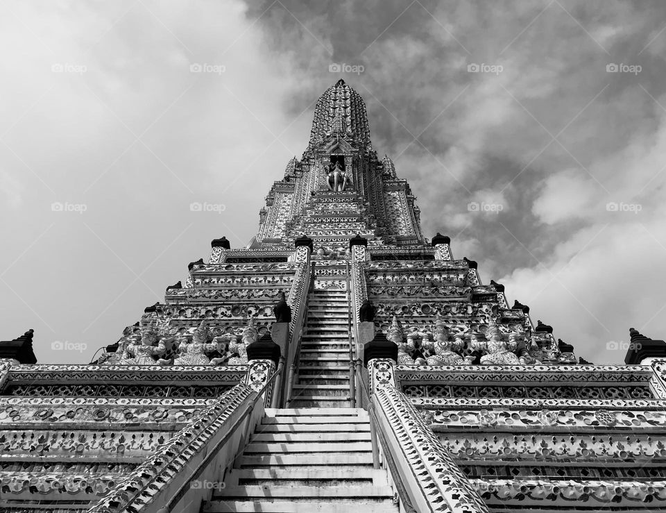 Photo number two of Arun temple jn Bangkok,Thailand with sunshades infront of the building. This is one of the most well known as combination architectural culture that all tourists around the world would like to visit.