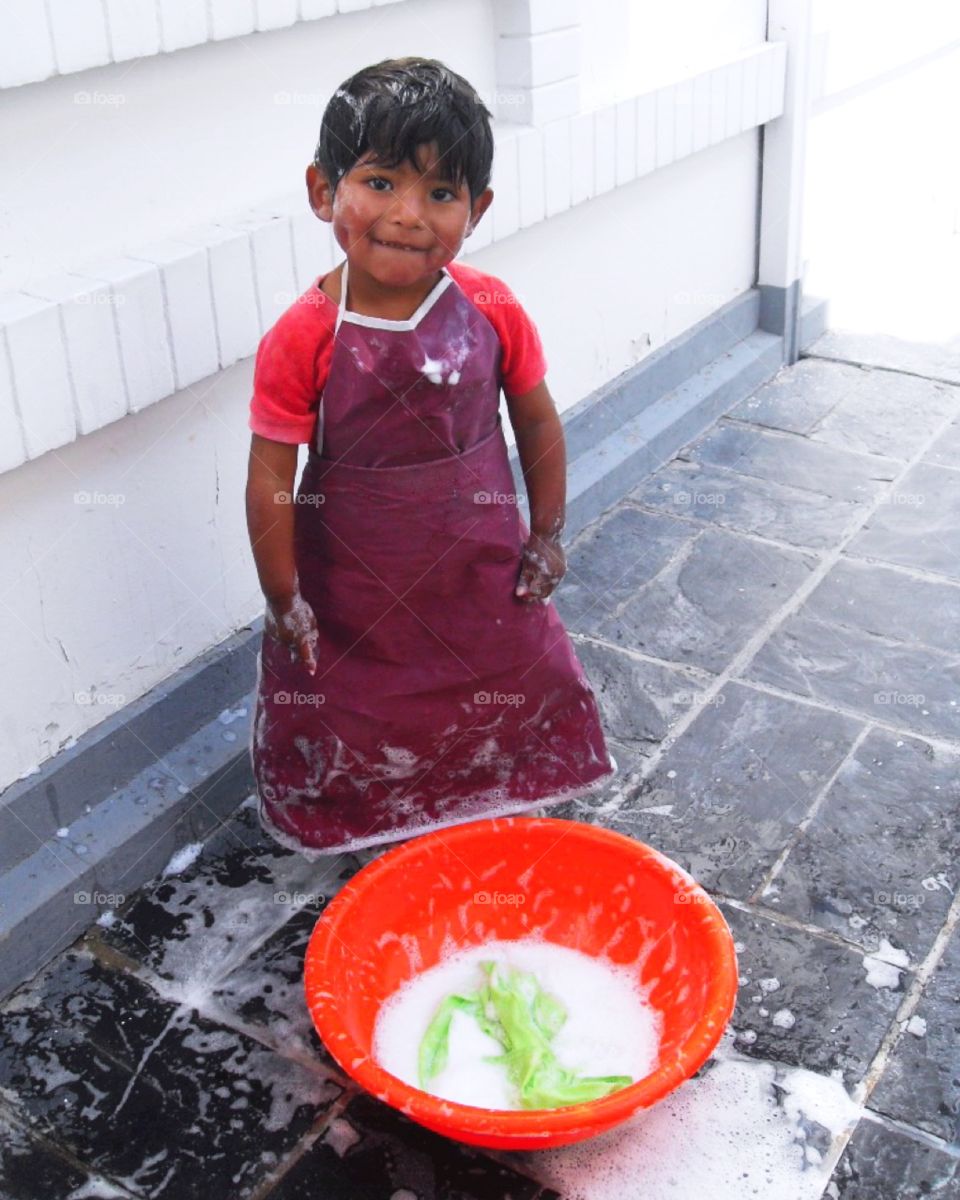 A young Bolivian boy helping do house chores