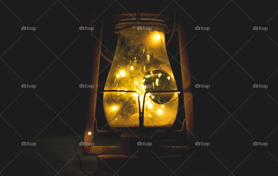 Amazing rustic old lantern glowing with fairy string lights!