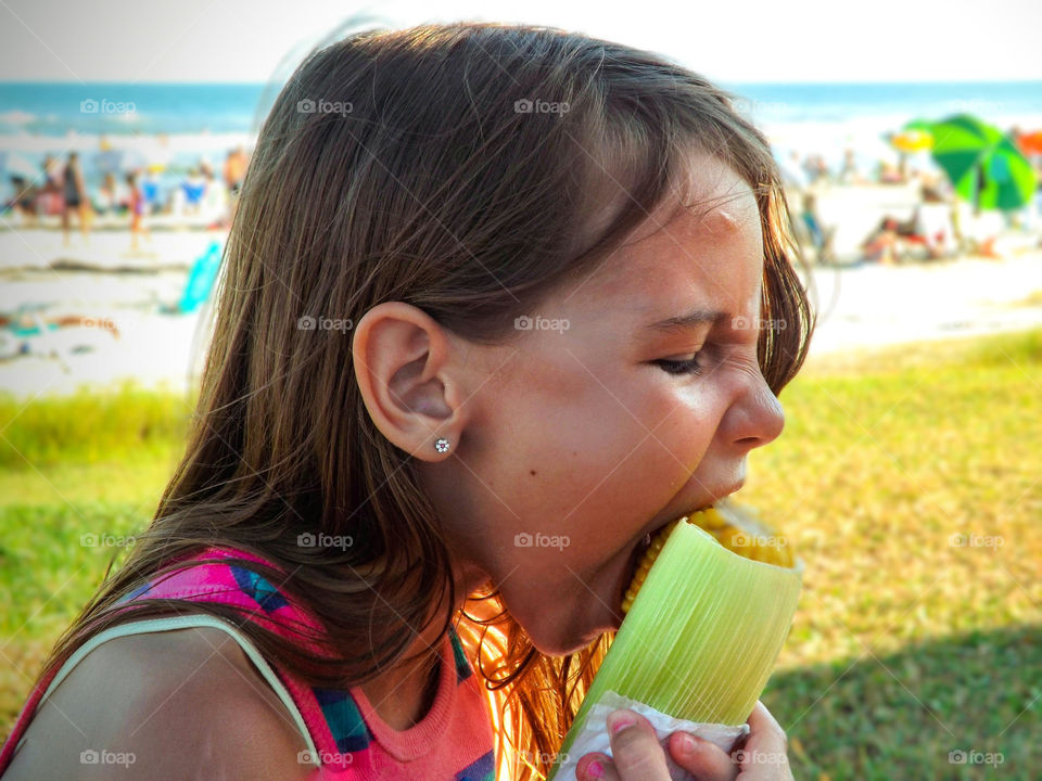 girl eating corn