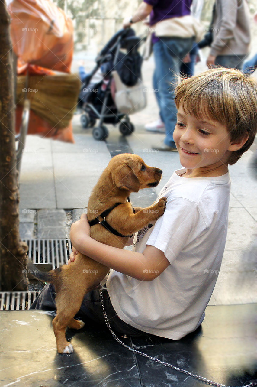 Happines. A kid with a puppy