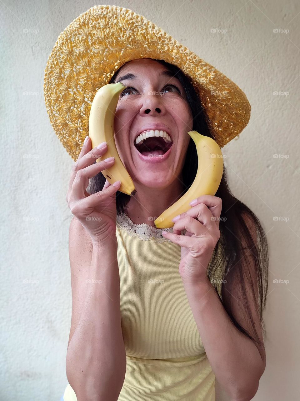 Funny Portrait of Beautiful Smiling Woman with bananas