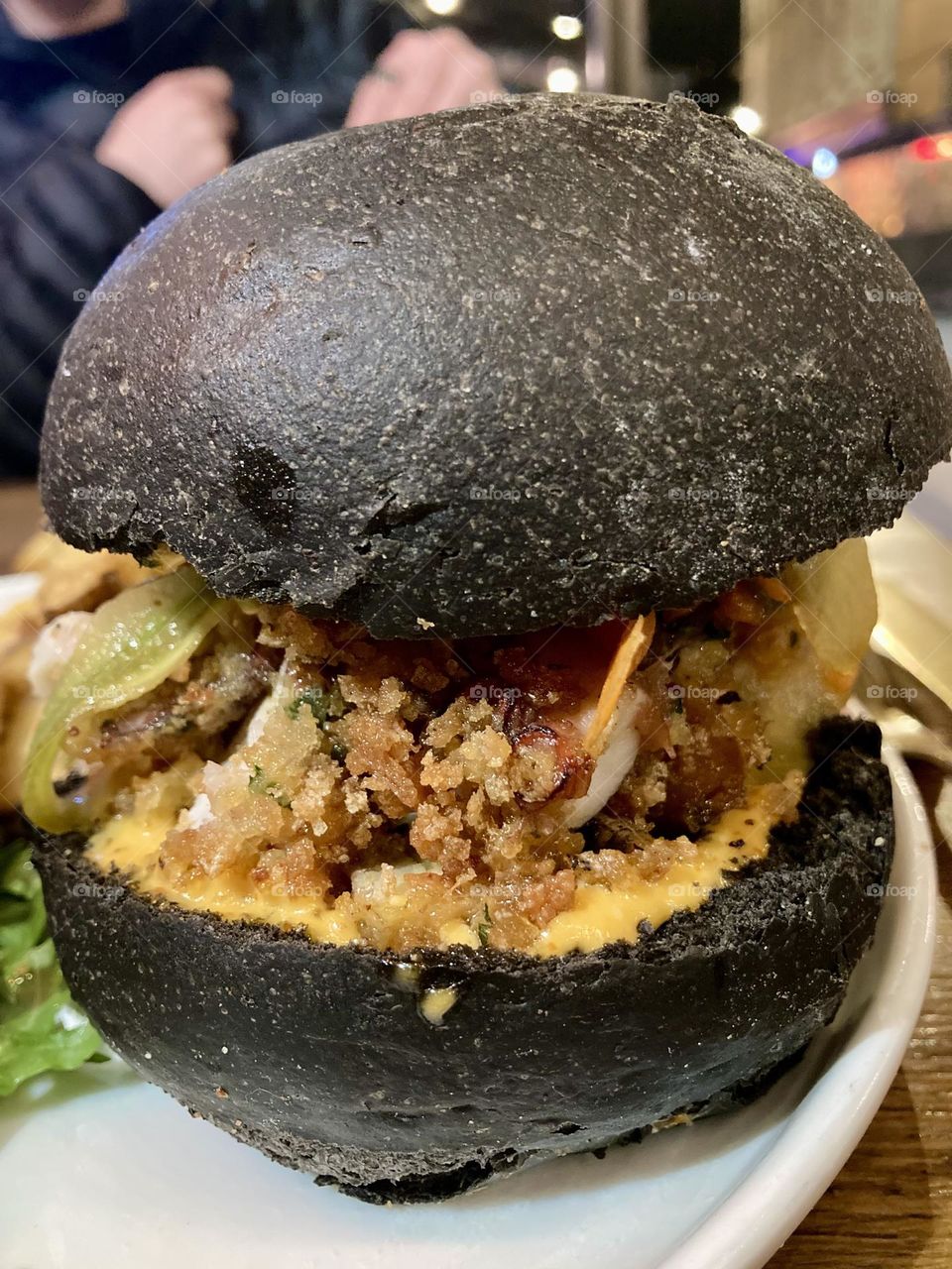 The Poulpe Fiction Burger with a black bun.