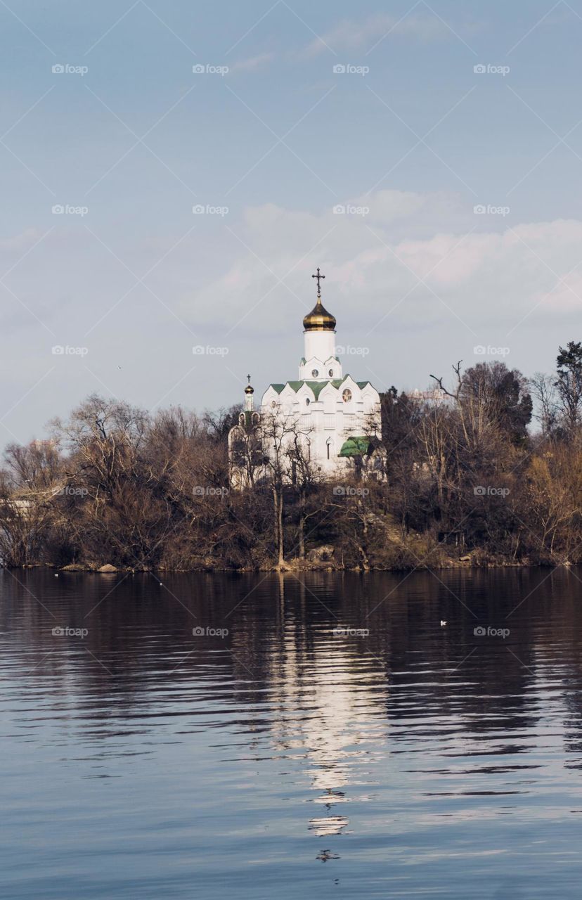 Urban nature- the Ortodox church on a riverbank 