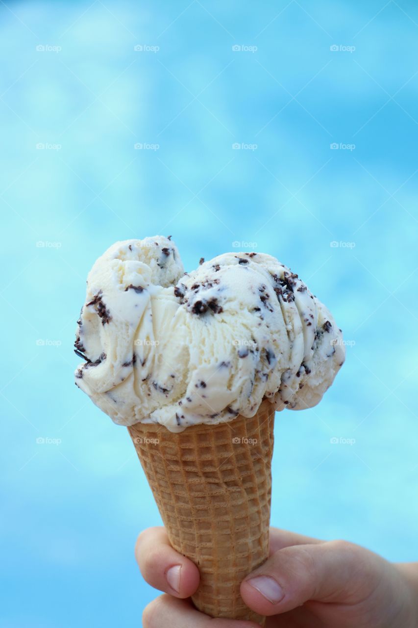 Choco chip ice cream cone in hand