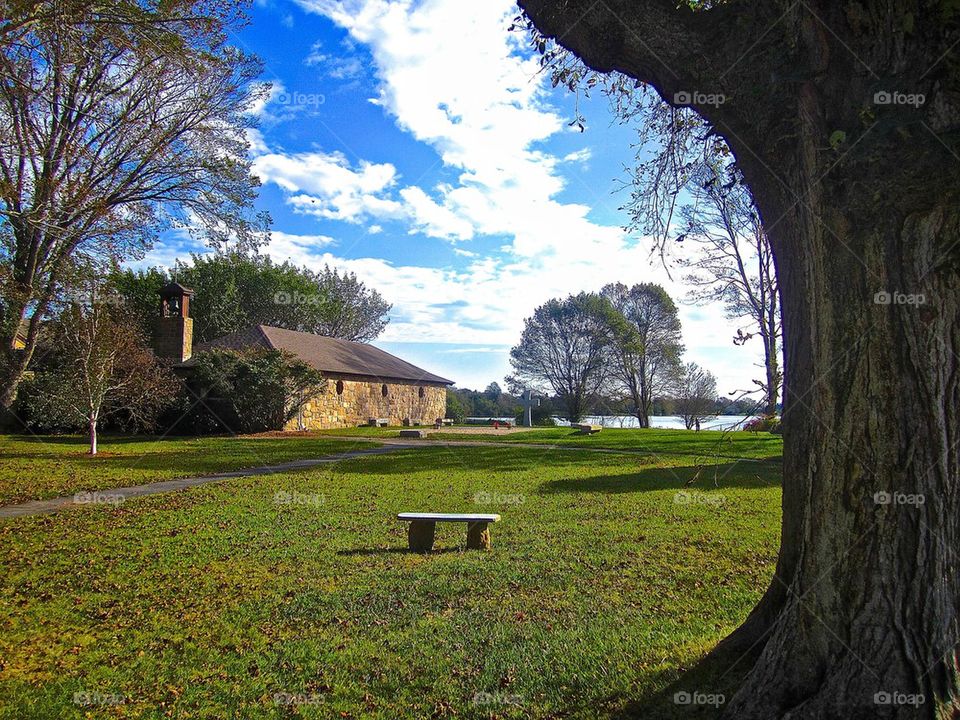 View of stone house in the garden near lake