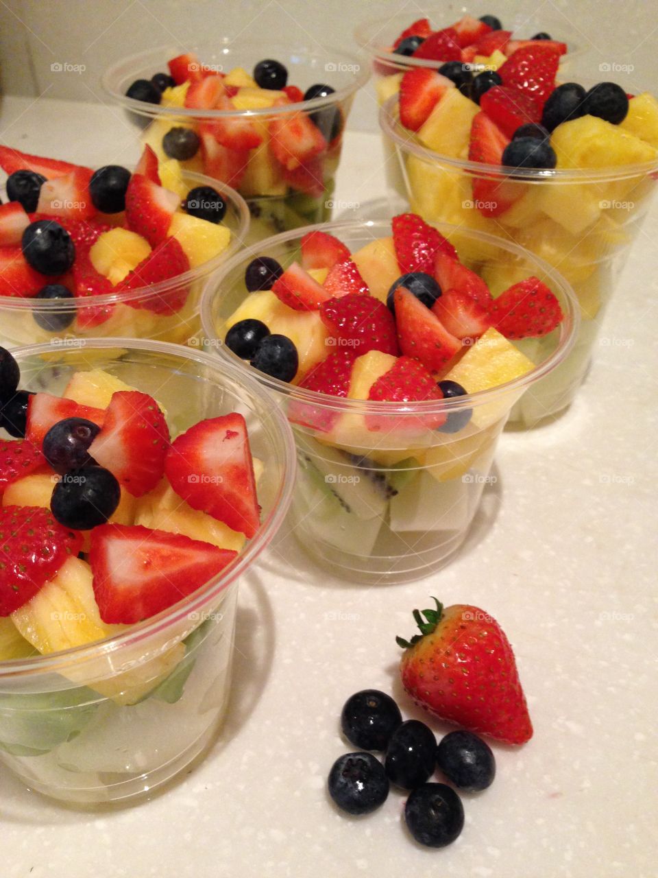 Fruit salad cup being prepared fresh 