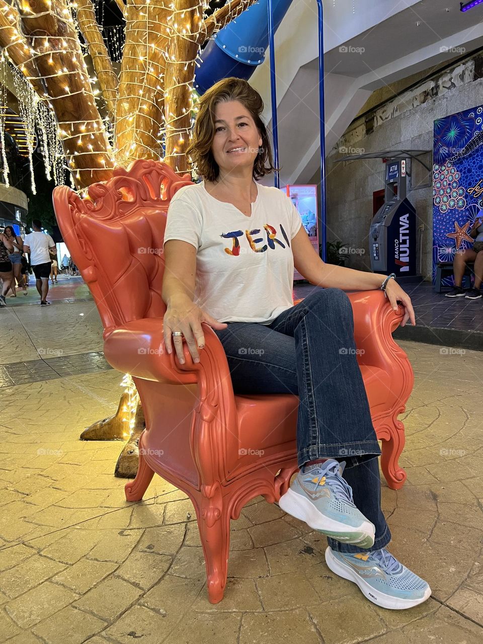 Woman sitting in orange big chair 