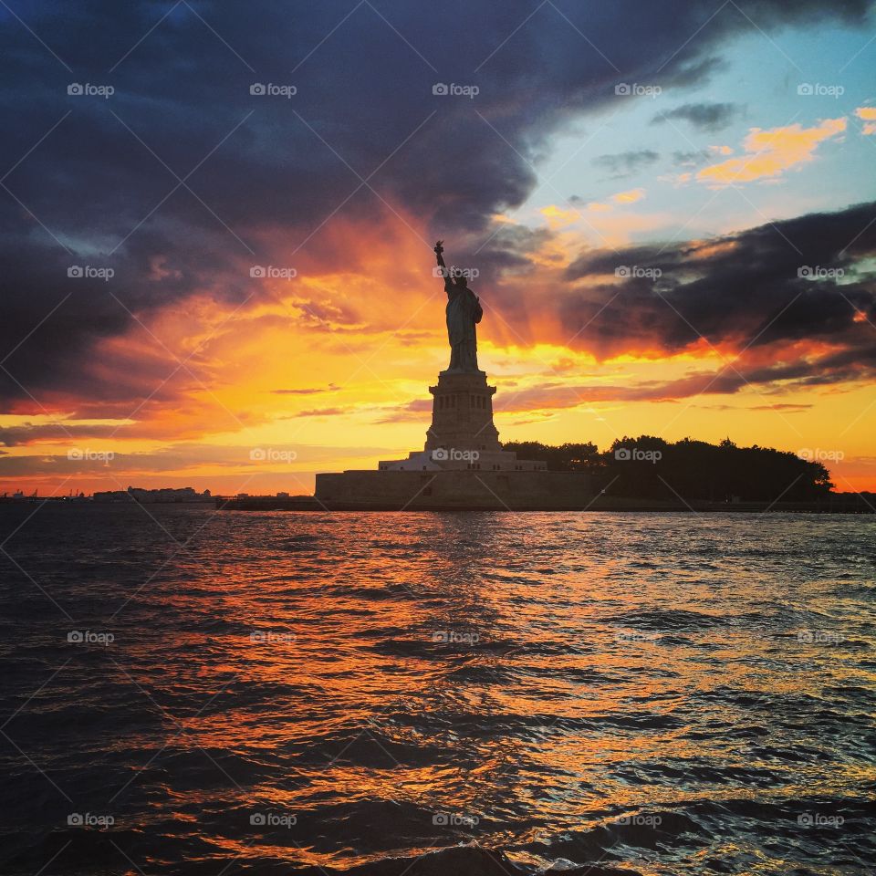 Statue of Liberty at Sunset. Sailing around Manhattan at dusk to catch a glimpse of Lady Liberty. NYC 2015