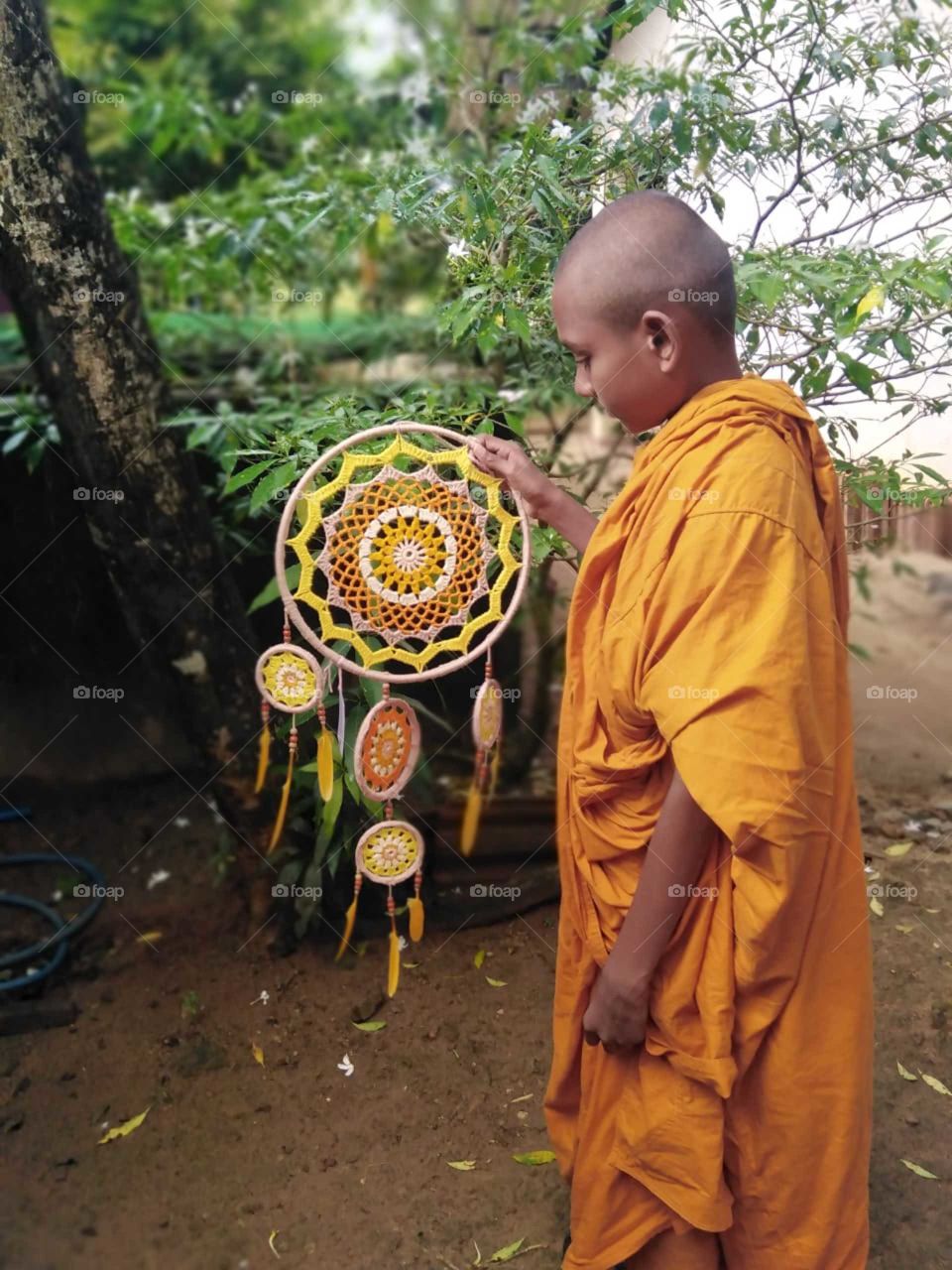 Little monk with dreamcatcher 