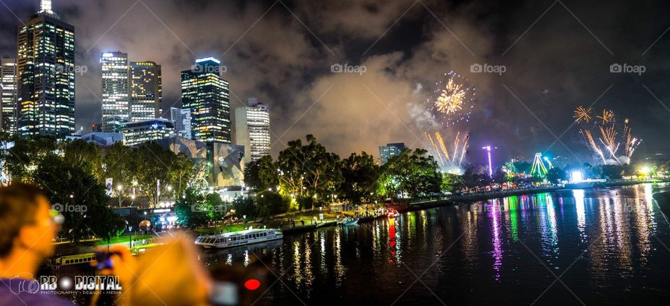 Melbourne City during Moomba fireworks 2018. From on top of Queen's Bridge and across the Yarra River at night.