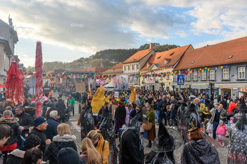 Crowds of people wearing masks and partying in town square during carnival season in samobor, Croatia