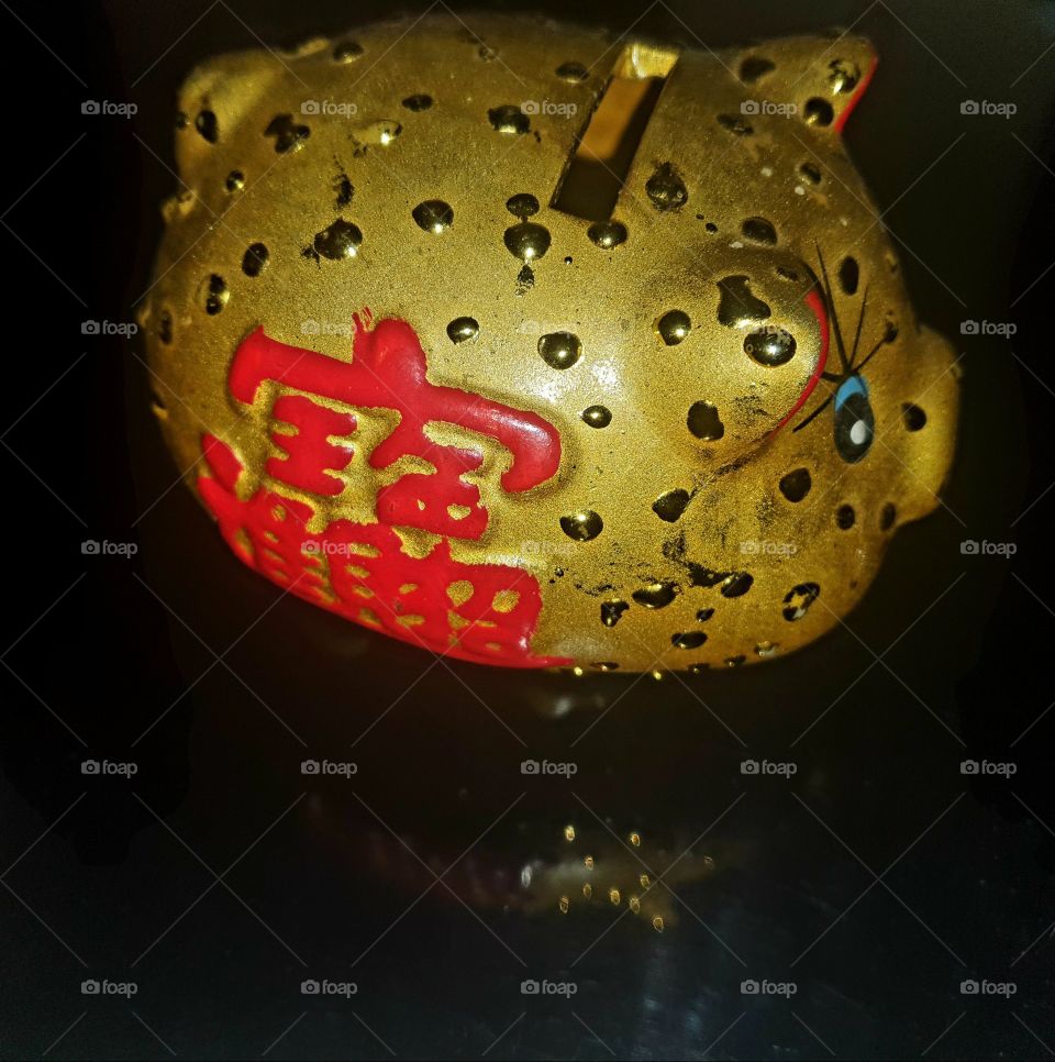 Chinese small piggy bank with red chinese sign.