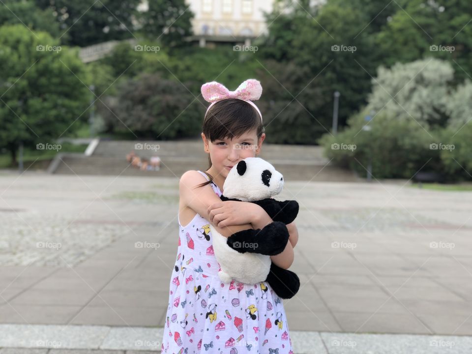 Little girl with plush Panda