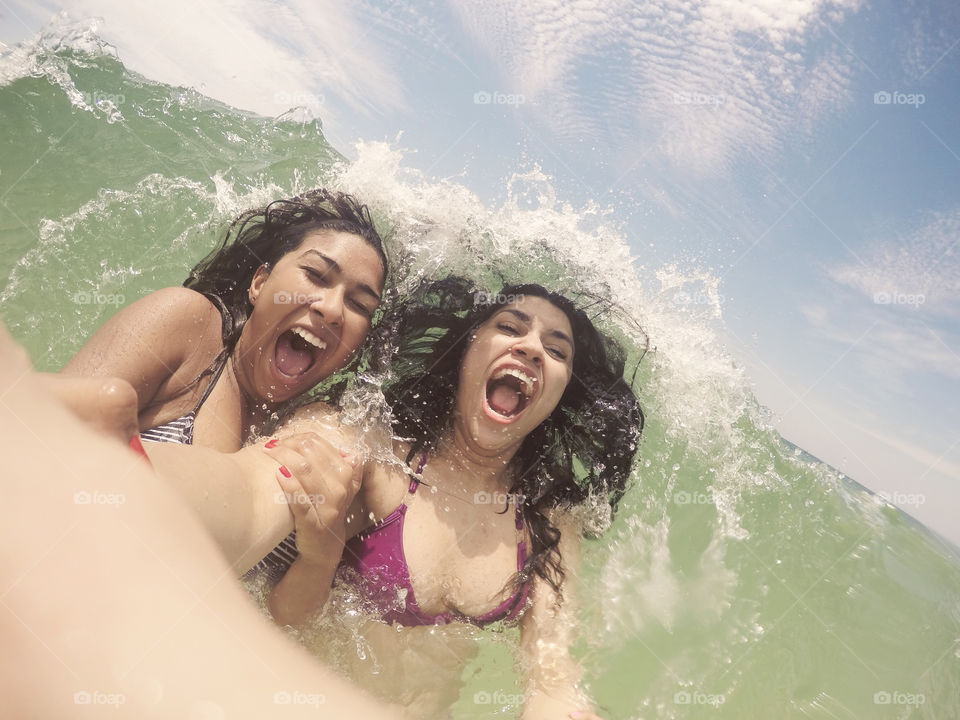 Happy woman enjoying in splashing wave