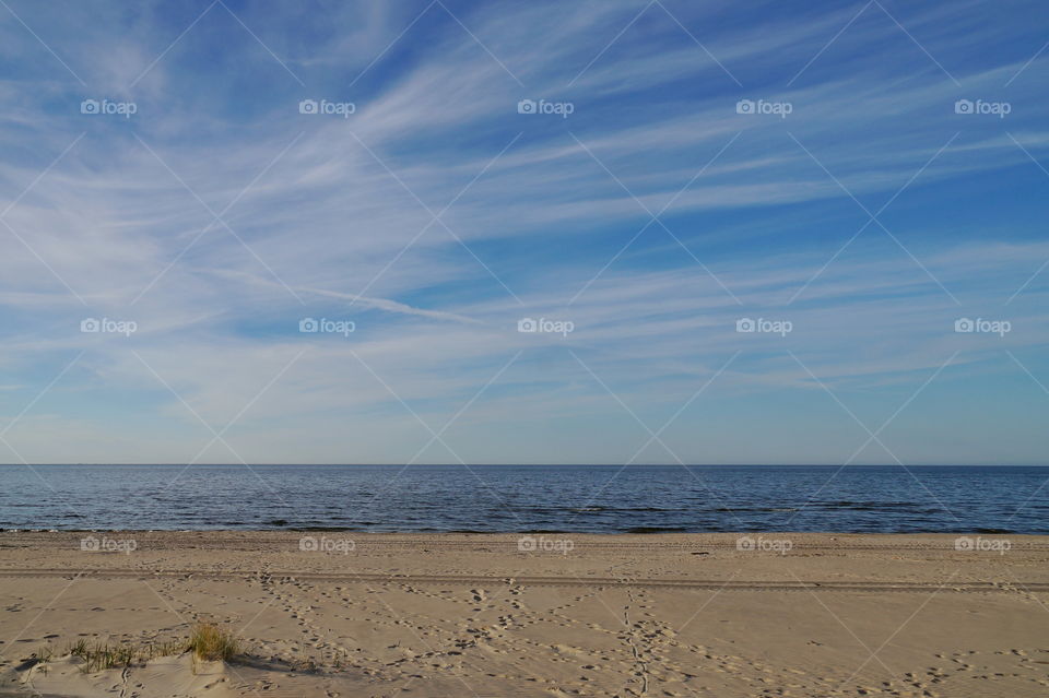 Deserted seashore on a summer day blue sky