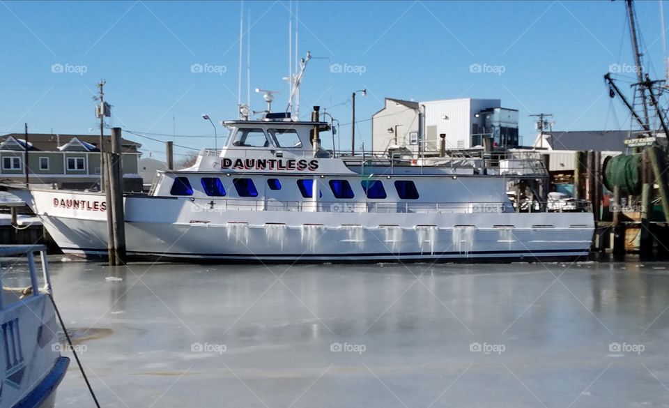 Fishing Boat frozen in Ice Water