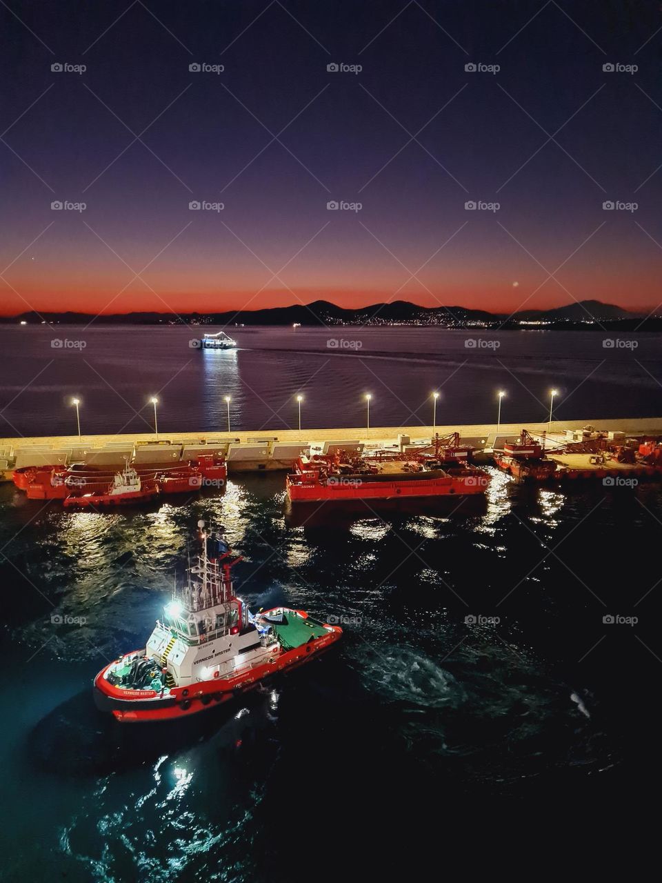 boats at the port lit up at night
