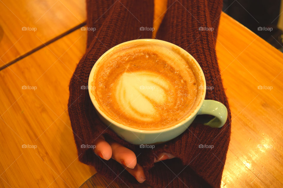 A cup of coffee and a feeling of love. This warmly photo represents a warmly heart and a feeling of love and care :)